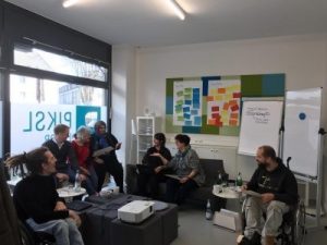 peer researcher discuss together in a sitting circle