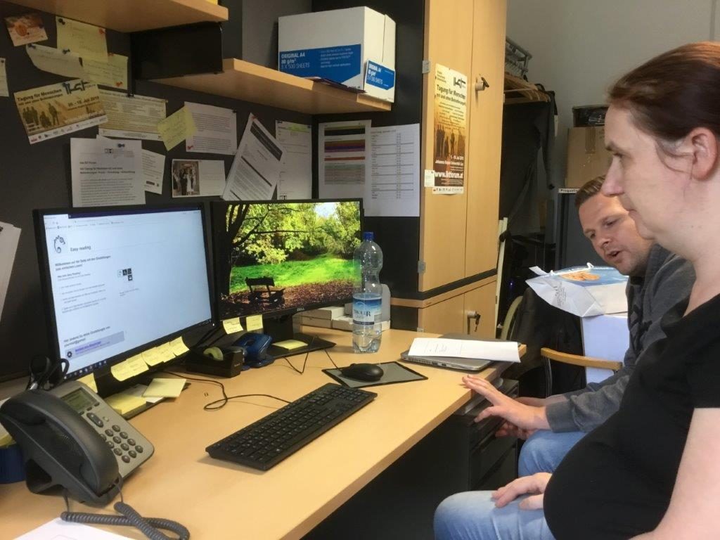 A Peer Researcher and a Developer sit together in front of the Easy Reading Program