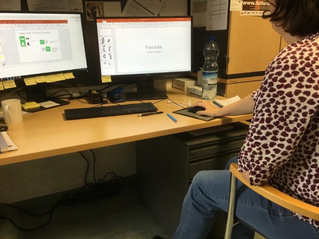 Peer researcher sits at the computer looking at various symbols.