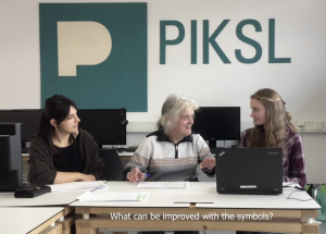 Three women sitting next to each other in front of one Computer at PIKSL.