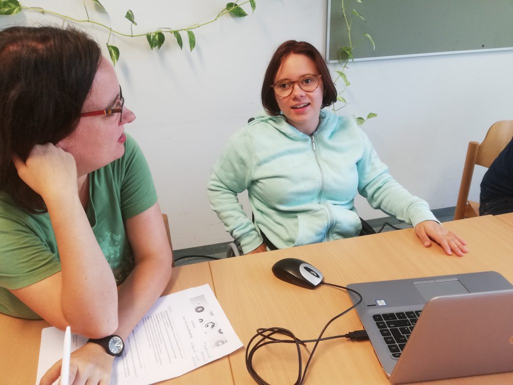 Two women sitting next to each other at a table.