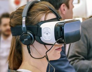 A young girl with VR glasses and a headset 